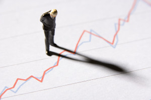 man staring down at graph