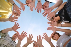 people putting thier hands in a circle